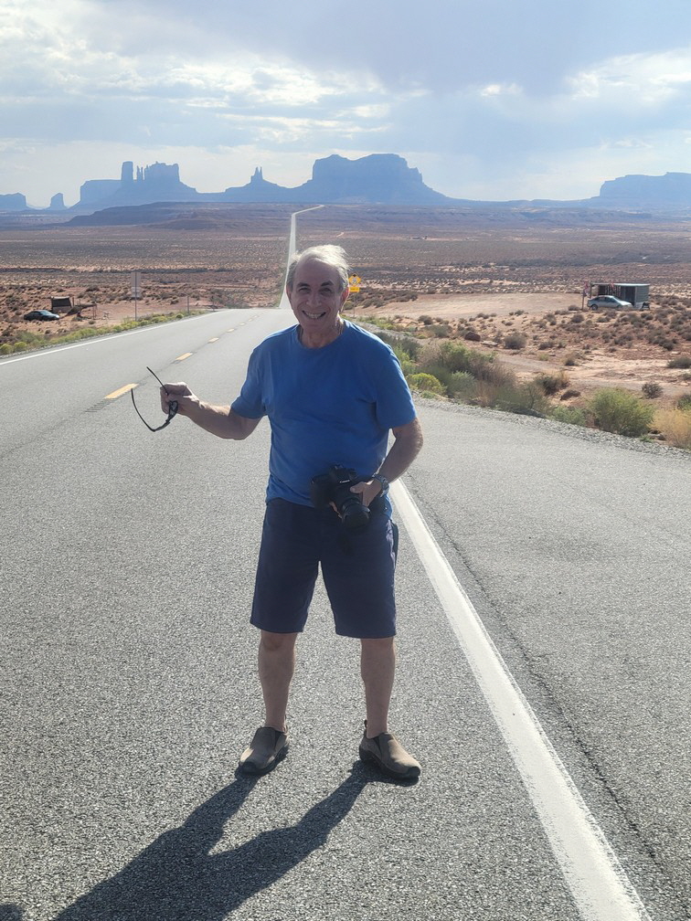 Bruce at the Forest Gump stop on the road to Monument Valley (in the background)